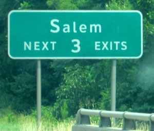 A guide sign is shown with the legend "Salem NEXT 3 EXITS." The lower-case letters of the word Salem are much smaller than the accepted height for the corresponding initial upper-case letter.