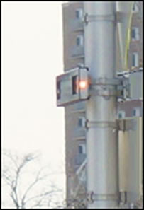 Figure 2b - the photograph is a close-up of the pilot light and the box mounted to the pole.