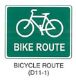 Pedestrian and Bicycle Sign "BICYCLE ROUTE (D11-1)" is shown as a horizontal rectangular green sign with a white border and legend. It shows a symbol of a bicycle above the words "BIKE ROUTE."