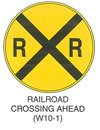 Railroad and Light Rail Transit Grade Crossing Sign "RAILROAD CROSSING AHEAD (W10-1)" is shown as a round yellow sign with a black border and legend. A black "X" covers the sign, and two "R's" are shown in the left and right quadrants of the sign.