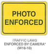 Warning Sign "TRAFFIC LAWS ENFORCED BY CAMERA (W16-10)" is shown as a horizontal rectangular sign with the words "PHOTO ENFORCED" on two lines. This sign was anticipated for inclusion in the 2003 edition of the MUTCD at the time of this printing.