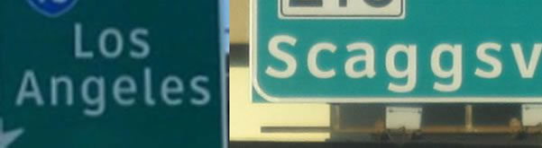 There are two road signs shown. Both have a green background and white lettering.  The first reads: Los Angeles.  The second is only partly legible and reads: 'Scaggsv'.  The second images words start close to the edge of the sign.