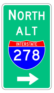 A vertical rectangular single sign with a green background color.  It includes a white directional arrow above which is a full color Interstate route shield above which is the word "Alt" in white letters above which is a white cardinal direction word legend.