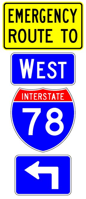 A sign assembly comprised of a white-on-blue directional arrow auxiliary sign above which is a full color Interstate route shield sign above which is a white-on-blue cardinal direction auxiliary sign above which is a supplemental plaque with the legend "Emergency Route To" in black letters on a yellow background.