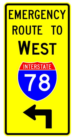 A vertical rectangular single sign with a yellow background color.  It includes a black directional arrow above which is a full color Interstate route shield above which is a black cardinal direction word legend above which are the words "Emergency Route To" in black letters.