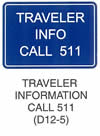 Motorist Services and Recreation Sign "TRAVELER INFORMATION CALL 911 (D12-5)" is shown as a horizontal rectangular blue sign with a white border and legend. It shows the words "TRAVEL INFO CALL 511" on the next three lines.
