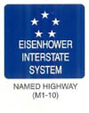 Guide Sign "NAMED HIGHWAY (M1-10)" is shown as a square blue sign with a white border and legend. It is shown with five white five-point stars in a five-point star pattern above the words "EISENHOWER INTERSTATE SYSTEM" in a sans serif typeface on three lines.