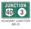 Guide Sign "ROADWAY JUNCTION (M2-2)" is shown as a green sign with a white border. It shows the word "JUNCTION" in white on the top line and, on the bottom line, the black numeral "47" is shown on a white U.S. shield to the left of a black numeral "3" shown on a white disk.