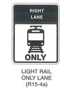 Railroad and Light Rail Transit Grade Crossing Sign "LIGHT RAIL ONLY LANE (R15-4a)" is shown as a vertical rectangular sign with a black panel on the top third of the sign. The words "RIGHT LANE" are shown in white on the panel above a black symbol of a light rail transit vehicle on a cross section of track above the word "ONLY" in black.