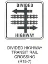 Railroad and Light Rail Transit Grade Crossing Sign "DIVIDED HIGHWAY TRANSIT RAIL CROSSING (R15-7)" is shown as a square sign. It shows the words "DIVIDED" and "HIGHWAY" above and below a symbol of a four-legged intersection with a left-pointing arrow at the top, a right-pointing arrow at the bottom, and a vertical road crossing these two arrows and continuing in each direction. Between the two sections of highway, two horizontal tracks are shown.