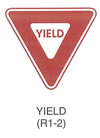 Regulatory Sign "YIELD (R1-2)" is shown as a downward-pointing equilateral triangle with a wide red border and the legend "YIELD" in red on a white background.