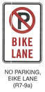 Pedestrian and Bicycle Sign "NO PARKING, BIKE LANE (R7-9a)" is shown as a vertical rectangular white sign with a red border and legend. It shows a black letter "P" inside a red circle with a red diagonal slash superimposed on it above the words "BIKE LANE" in red on two lines.