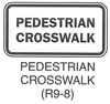 Pedestrian and Bicycle Sign "PEDESTRIAN CROSSWALK (R9-8)" is shown as a horizontal rectangular white sign with a black border and the words "PEDESTRIAN CROSSWALK" in black on two lines.