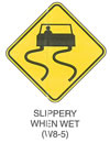 Warning Sign "SLIPPERY WHEN WET (W8-5)" is shown as a sign with a black symbol of car at the top of the sign. Two vertical wavy lines extend down from the car tires.
